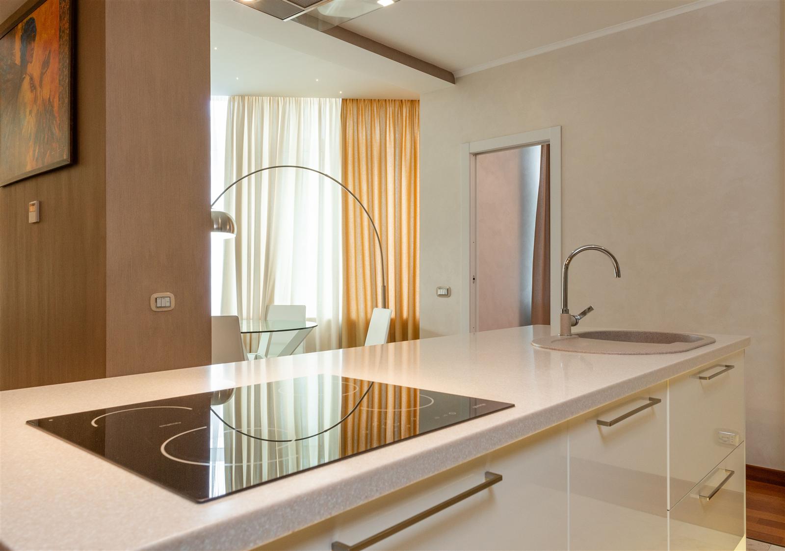 A modern kitchen island with a built-in cooktop and sink installed