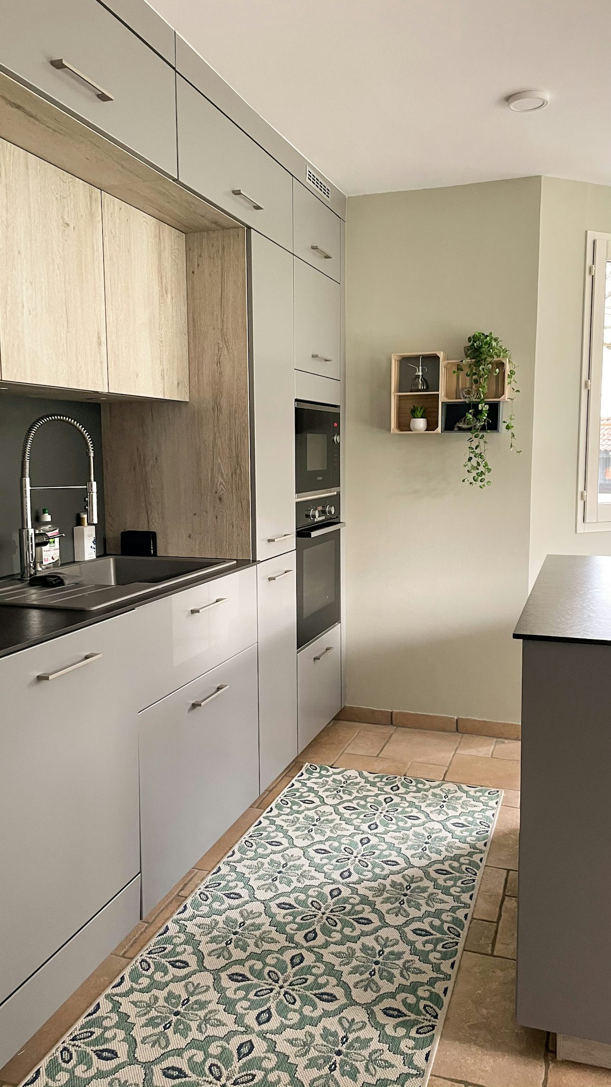 Small kitchen with black and white cabinetry making smart use of limited wall space