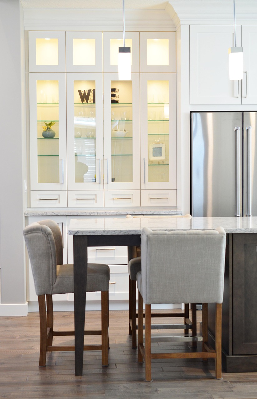 Small kitchen with white cabinets, counter seating, and space-efficient storage
